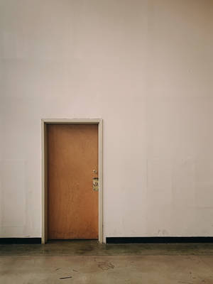 Plain Brown Wooden Door Inside A Structure Wallpaper