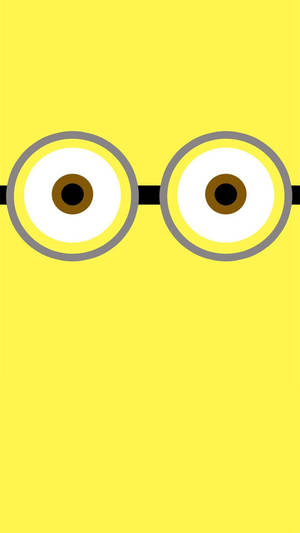 Playful Minion Eyes On A Cute Yellow Background Wallpaper