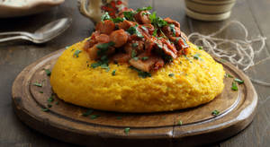 Polenta Taragna Served On A Wooden Board Wallpaper