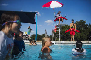 Pool Lifeguard Watching Over Kiddie Pool Wallpaper