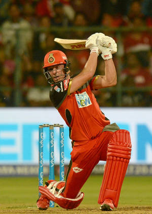Power Stance - The On-field Strength Of Ab De Villiers In Rcb Gear Wallpaper
