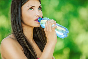 Pretty Brunette Woman Drinking Water Wallpaper