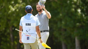 Professional Golfer Chris Kirk In Conversation With His Caddie During A Golf Tournament Wallpaper