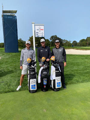 Professional Golfer Corey Conners With Fellow Golfers On The Course Wallpaper