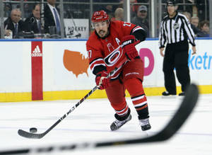 Professional Ice Hockey Player Justin Faulk In Action Wallpaper