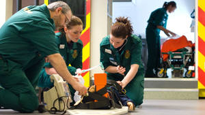 Professional Paramedic Team Providing First Aid Wallpaper