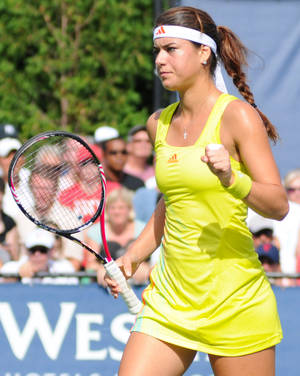 Professional Tennis Player Sorana Cirstea Sporting Yellow Adidas Outfit Wallpaper