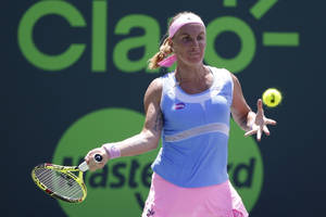 Professional Tennis Player Svetlana Kuznetsova Performing Forehand Stroke Wallpaper