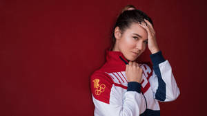 Proud Olympic Athlete In Red Competing At The Highest Level Wallpaper