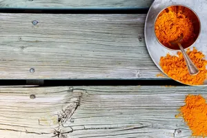Pure Turmeric Powder In Its Vibrant Orange Glory Wallpaper