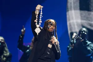 Quavo Performingon Stagewith Mask Wallpaper