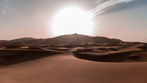 Radiant Desert Sun Against A Pristine Sky Wallpaper