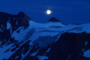 Radiant Full Moon Illuminating The Night Sky Wallpaper