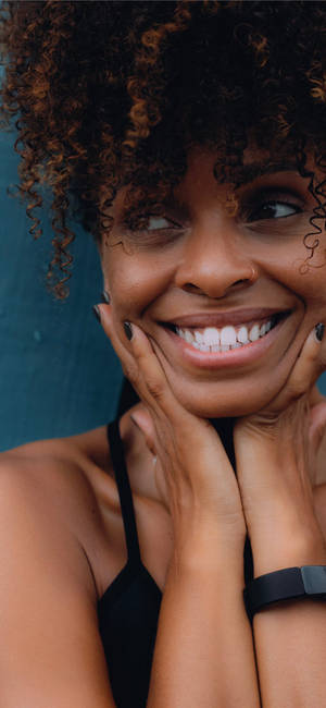 Radiant Smile Of A Black Girl Wallpaper