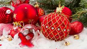Red Aesthetic Christmas Balls In Snow Wallpaper