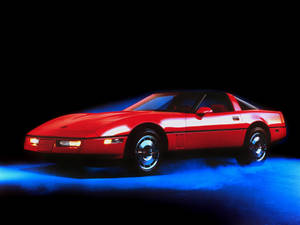 Red C4 Corvette In Blue Smoke Wallpaper