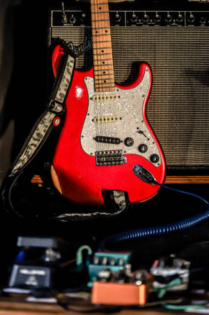 Red Electric Guitar With Amplifier Wallpaper