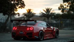 Red Gtr Racing Car In Road Wallpaper