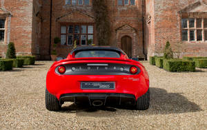 Red Lotus Car In A Red Brick Manor Wallpaper