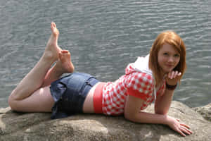 Redhead Girl Feet On Rock By River Wallpaper