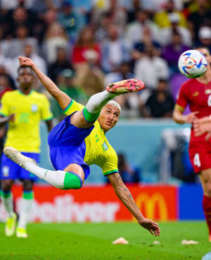 Richarlison De Andrade Kicking A Ball Wallpaper