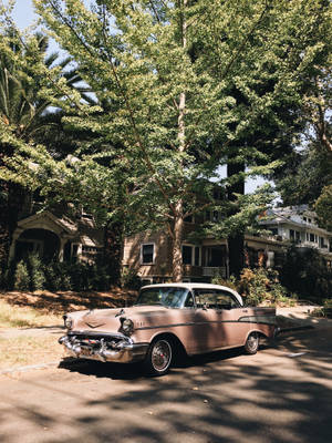 Ride In Vogue In A Vintage Pink Car Wallpaper