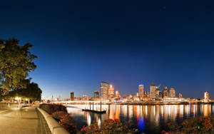 Riverside Concrete Walkway At Night Wallpaper