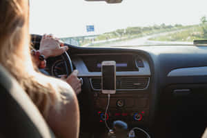 Road Trip Adventure Begins - Scenic Landscape With Vehicle On The Horizon Wallpaper