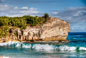 Rocky Cliff On A Beach Wallpaper