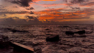 Rocky Dusk Sea Background Wallpaper