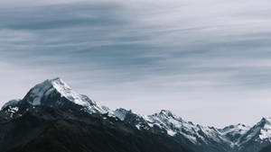 Rocky Mountain Beneath Gray Sky Wallpaper