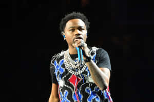 Roddy Ricch Strikes A Pose During A Performance Wallpaper