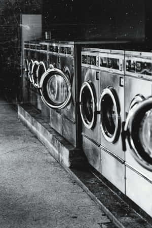 Rowof Washing Machinesin Laundromat Wallpaper