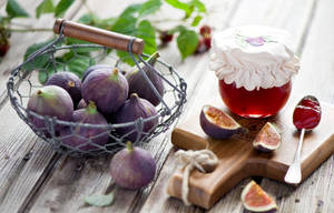 Rustic Display Of Figs Jam On A Dining Table Wallpaper