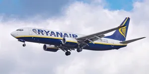 Ryanair Flying With Clouds Behind It Wallpaper