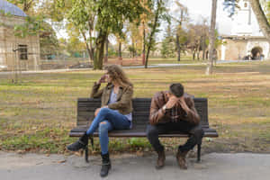 Sad Couple Park Bench Wallpaper