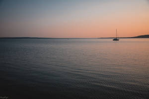 Sailing Alone In Calm Waters Wallpaper