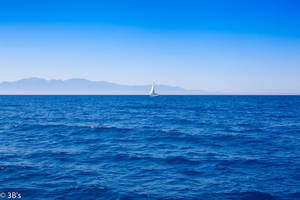 Sailing Boat On Blue Waters Wallpaper