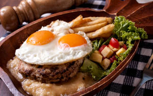 Salisbury Steak Crowned With Sunny Side Up Eggs Wallpaper