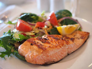 Salmon Dish With Vegetables And Lemon Slices Wallpaper