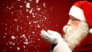 Santa Claus Blowing Snow Wallpaper