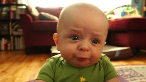 Sassy Sour-faced Sweetheart - Adorable Baby Making A Funny Sour Face Wallpaper