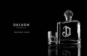 Savoring Luxury With Deleon Tequila Bottle And Glass Wallpaper