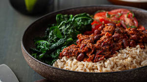 Savory And Hearty Bowl Of Chili Con Carne Served With Rice Wallpaper