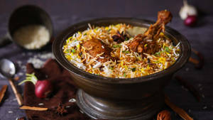 Savory Chicken Biryani In Iron Dish Wallpaper