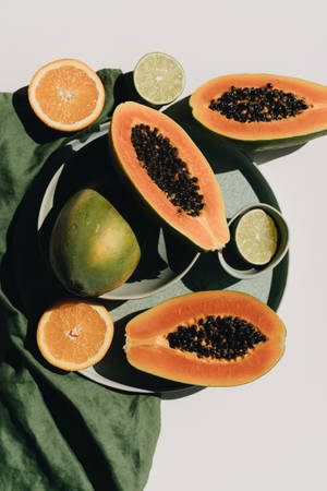 Seeded Papaya In Green Minimalist Arrangement Wallpaper