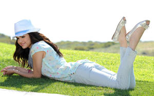 Selena Gomez Laying On Grass Wallpaper
