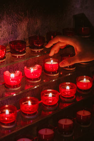 Serene Dark Red Candle Lights Wallpaper