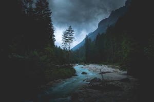 Serene Scene Of A Lake Nestled In The Mountains At Dawn Wallpaper