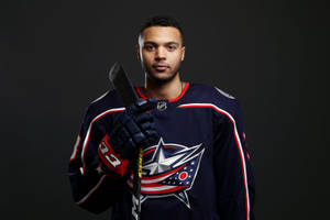 Seth Jones Posing With Hockey Stick For Columbus Blue Jackets Wallpaper